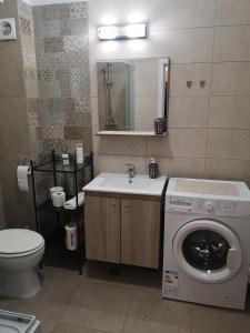 uma casa de banho com uma máquina de lavar roupa e um lavatório em Masha em Mamaia Nord – Năvodari
