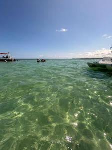 a large body of water with boats in it at Suites Mar Azul- São José - Maragogi in São José da Coroa Grande