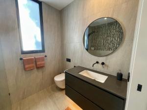 a bathroom with a sink and a mirror at Tanderrum Guest Suite in Point Lonsdale