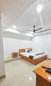 a bedroom with a bed and a ceiling fan at The PENTHOUSSE near ION Exam Centre & Airport in Guwahati