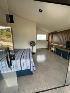 a bedroom with a bed and a desk in it at Casa em Monte das Gameleiras-RN in Monte das Gameleiras