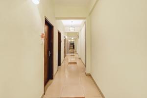 a hallway with white walls and a long corridor at Townhouse Hw Residency in Dehradun