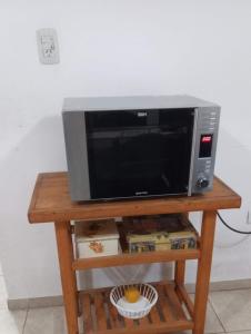 a microwave oven sitting on a wooden table at Casa festival Jesús María in Colonia Caroya