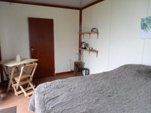 a bedroom with a bed and a table and a door at Monte Santa Lucia 