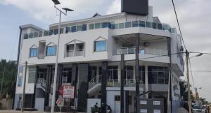 a white building with a lot of windows at DIVINE GRACE RESIDENCE INN in Agblangandan