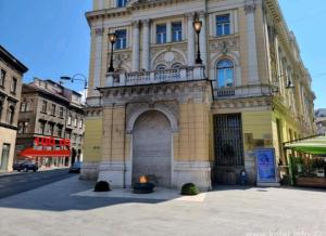 Un edificio con un fuoco davanti di Cosy single room with balcony in top location a Sarajevo