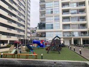 a playground in front of a apartment building at Puerto santa Ana Torres Bellini in Guayaquil