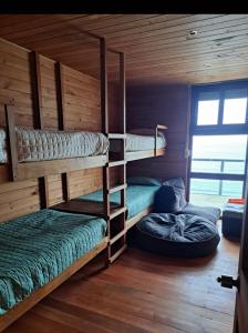 a room with three bunk beds and a bed at Casa hermosa vista in Boca Pupuya