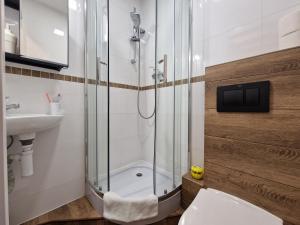 a bathroom with a shower and a toilet and a sink at Hostel Helvetia - PRIVATE ROOMS in CITY CENTER and OLD TOWN in Warsaw