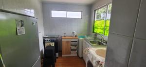 a small kitchen with a sink and a stove at Alojamiento La Serena CQ in La Serena
