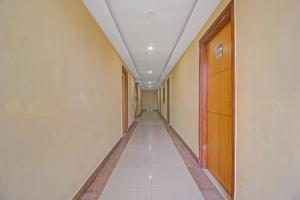 a corridor of an office building with a long hallway at Super Collection O Regal Near ISKON TEMPLE , ABIDS in Hyderabad +39 photos