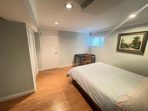 1 dormitorio con 1 cama y 1 mesa con silla en Arbutus violet room, en Vancouver