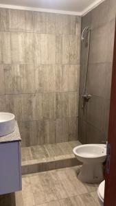 a bathroom with a toilet and a sink at Duplex del Parque y Balneario in Necochea