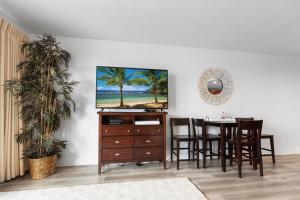 a dining room with a table and a dresser at Amazing Beach Ocean View Condo! Free Beach ChairsService! Sleeps 8! by Dolce Vita Getaways PCB in Panama City Beach