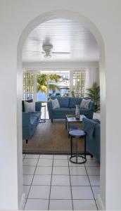 a living room with blue couches and a table at The Anchorage #5 a 3 bedroom Waterfront Condo in Rodney Bay condo in Gros Islet