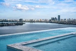 uma piscina com vista para a cidade em L7 WEST LAKE HANOI By LOTTE em Hanói