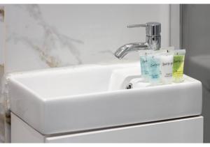 a sink with two toothbrushes sitting on top of it at Brand New Homey and Stylish Perfect for Travellers in London