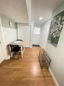 a hallway with a desk and a table in a room at Arbutus Jasmine room in Vancouver +3 photos