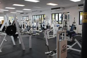 a gym with rows of treadmills and machines at Fajardo Inn Resort in Fajardo