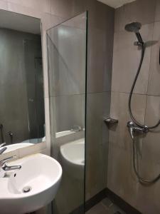 a bathroom with a shower and a sink and a sink at Avaria KL in Kuala Lumpur