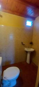 a bathroom with a white toilet and a sink at Los Cactus Planta Alta in La Rioja