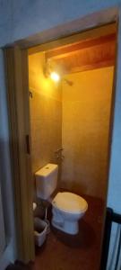 a bathroom with a white toilet and a light at Los Cactus Planta Alta in La Rioja