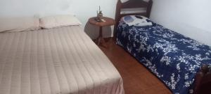 a bedroom with a bed and a side table at Los Cactus Planta Alta in La Rioja