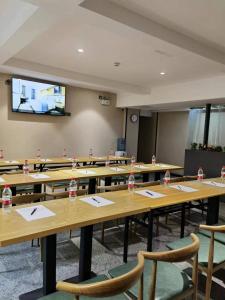a classroom with tables and chairs with water bottles on them at The Best Time Hotel Pazhou-Free shuttle bus for canton fair in Guangzhou
