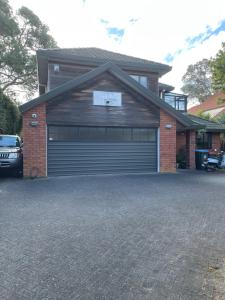a garage with a car parked in front of it at Rooms in Epsom House in Auckland