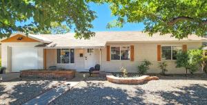 a house with a landscaping in front of it at UPtown. UPscale. UPgraded. 3bd/2ba +Garage & Yard! in Albuquerque