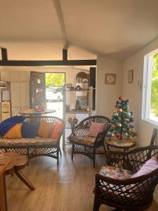 a living room with a christmas tree in the middle at Casa Encanto da Barra in Fortim