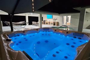 a large hot tub in a living room with at Tranquil Oasis Retreat in Golden Gate Estates in Naples