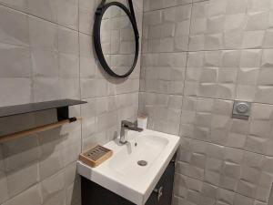 a bathroom with a sink and a mirror at Appartement Les Deux Alpes, 3 pièces, 8 personnes - FR-1-516-217 in Les Deux Alpes