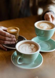 two cups of coffee sitting on a wooden table at Renaissance Xi'an Hotel in Xi'an