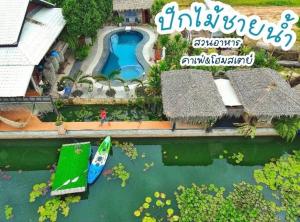 an aerial view of a resort with a boat in the water at ปีกไม้วิลล่าb2 