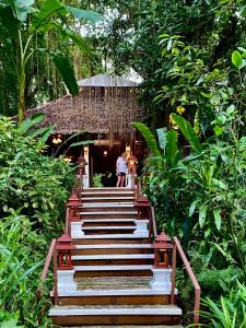 a stairway in a garden with people walking down it at Fern Resort Mae Hong Son in Mae Hong Son