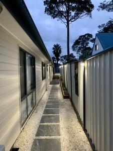 a walkway between two houses with lights on at Erowal Bay Guesthouse Jervis Bay in Erowal Bay