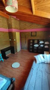 a room with a large bed and a wooden ceiling at Esquel house in Esquel