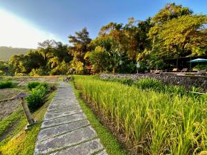a stone path through a field of grass at Fern Resort Mae Hong Son in Mae Hong Son