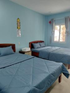 En eller flere senge i et værelse på Biển Ngọc Homstay