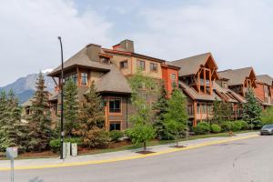 a large house on the side of a street at Solara Suite with Indoor Pool - Hot tub -Parking - GYM in Canmore
