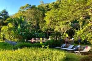 a group of lounge chairs and people in a park at Fern Resort Mae Hong Son in Mae Hong Son