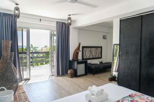 a bedroom with a bed and a balcony at Blanco Beach Resort Malapascua in Malapascua Island