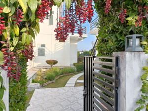 a garden with red flowers and a fence at Hriday Bhoomi - Luxury Cottages & Villa in Jim Corbett in Jhirna