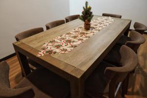 a wooden table with a christmas tree on top at Kota Kinabalu family Home in Kota Kinabalu