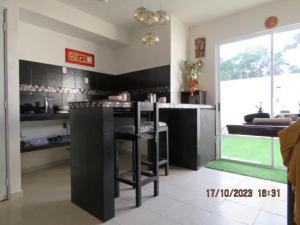 a kitchen with black cabinets and a counter top at Casa Turquesa in Cancún