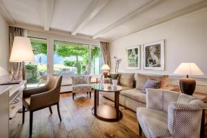 a living room with a couch and a table at Park Hotel Sonnenhof - Relais & Châteaux in Vaduz