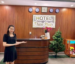 a woman standing in front of a hotel kitchenrite at Thiên Phước Hotel - 2/2/6a Thiên Phước- by Bay Luxury in Ho Chi Minh City