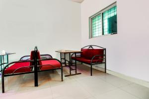 a dining room with red chairs and a table at OYO Flagship 69410 Sip & Bite Restaurant N Lodging in Mansar
