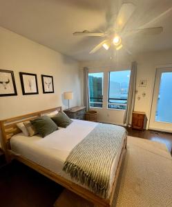 a bedroom with a bed and a ceiling fan at Charming Heritage Home with Mountain and City Views in Vancouver